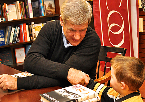 Hockey great Bobby Orr shakes hands with one of his littlest fans at a recent book signing at The Harvard COOP bookstore in Cambridge, Massachusetts.