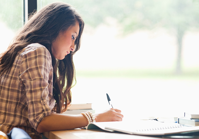 A girl student writing a whitepaper