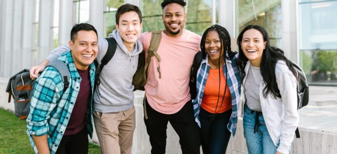 five students staying together outside the school building